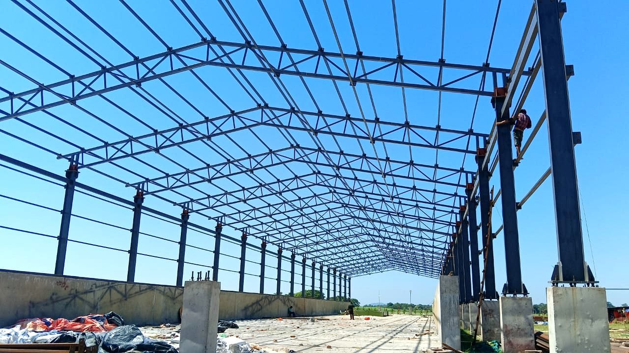 Steel roof truss structure fabricated by FabSteel on a warehouse site in Guwahati